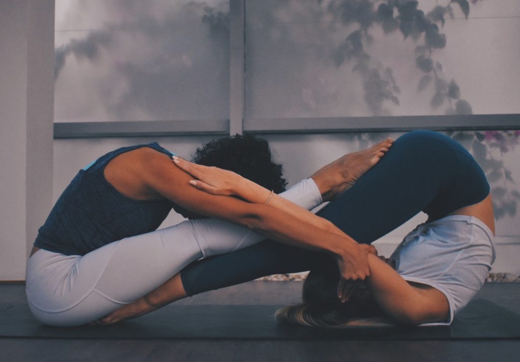 Two women in a yin and yang pose