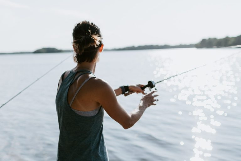 How to coach employees to think for themselves - Person holding fishing rod over the water