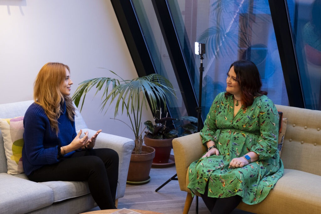 Still image from a coaching session showing two people in conversation—demonstrating the Coaching Two-Step™ method in a real work scenario.